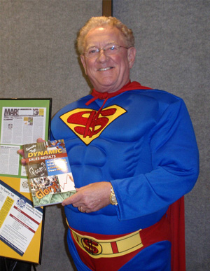 "Super" Sparky showing off book Dynamic Sales Results